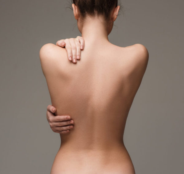 The beautiful woman's body on gray background